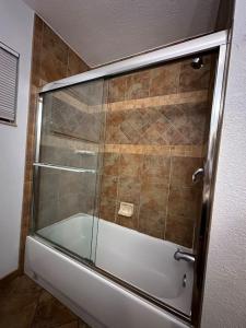a shower with a glass door in a bathroom at Cozy Private Rm Near Beach Travelers Welcome J1A shared home in Sarasota +46 photos