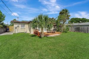 a yard with a house and a palm tree at Cozy Private Rm Near Beach Travelers Welcome J1A shared home in Sarasota
