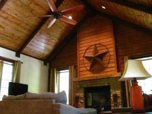 a living room with a ceiling fan and a fireplace at The Preserve, Craftsman Special Vacation Home by F in Sampson