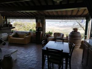 a living room with a table and chairs and a couch at Cantuccio di Val d'Orcia in Campiglia dʼOrcia
