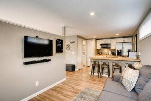 a living room with a couch and a tv on a wall at Olympic Studio - Workcation Hot Tub 4K Roku in Colorado Springs