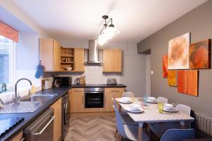 a kitchen with a table and a dining room at HOLLINS NOOK - Countryside House - Gateway to Lakes National Park in Burneside