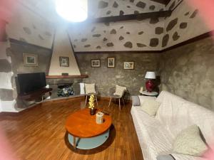 a living room with a white couch and a table at Casa La Candelaria - Moya in Moya