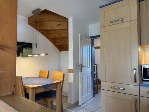 a kitchen with a table and a dining room at gemütliche Doppelhaushälfte in Burhave in Burhave