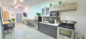 a kitchen with a stove and a counter top at 10 MIN FROM BEACH! 4 Queen Beds in Puerto Peñasco