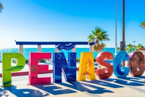 a sign for the beach with the ocean in the background at 10 MIN FROM BEACH! 4 Queen Beds in Puerto Peñasco +4 photos