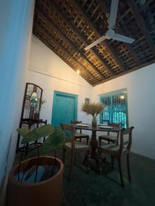 a dining room with a table and chairs and a ceiling at Serendib Veranda in Galle