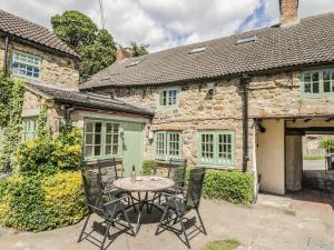 a table and chairs in front of a stone house at St Edmunds House in Bedale