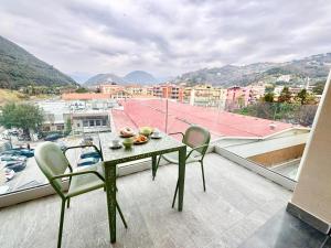 a table and chairs on a balcony with a view at Apartment Prestige in Finale Ligure