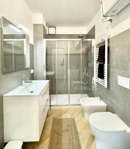 a bathroom with a toilet and a sink and a shower at Apartment Prestige in Finale Ligure