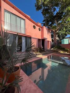 a house with a swimming pool next to a building at CALIXTO Villa 4 in Bucerías