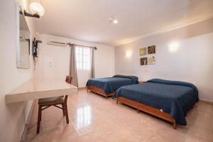 Postel nebo postele na pokoji v ubytování Hotel Rivemar