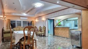 a dining room with a table and a kitchen at Spacious City View in Central Cairo in Cairo