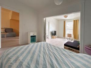 a bedroom with a large bed and a living room at Bright and spacious appartment in Montreal