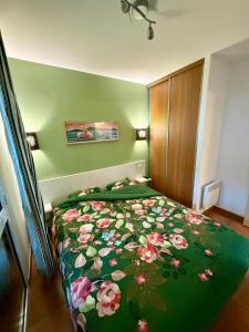a bedroom with a bed with a floral bedspread at Luzea, Domaine Iratzia in Saint-Jean-de-Luz +24 photos