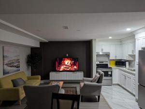 a living room with couches and a tv on a wall at Kings Palace Basement in Brampton
