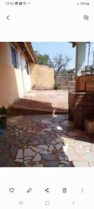 a picture of a stone walkway in front of a building at Pousada Paraíso Pedacinho Do Céu 2 in Águas de Lindóia
