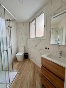 a bathroom with a shower and a sink and a toilet at Crysoyle Apartment II Barcelona Next to Camp Nou in Hospitalet de Llobregat +22 photos