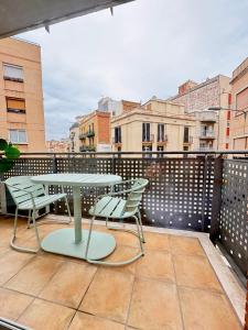 a patio with a table and chairs on a balcony at Crysoyle Apartment II Barcelona Next to Camp Nou in Hospitalet de Llobregat