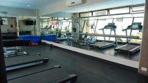a gym with treadmills and elliptical machines at Garden Park Hotel in San Miguel de Tucumán