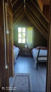 a bedroom with two beds and a window at Cabaña el rincón in Puerto Montt