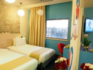 Ένα ή περισσότερα κρεβάτια σε δωμάτιο στο Grand Park Hotel Jerusalem