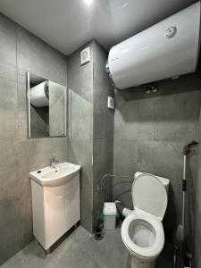 a small bathroom with a toilet and a sink at Sea in Varna City +20 photos