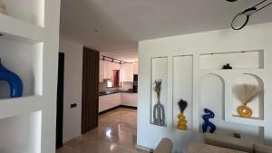 a kitchen and a living room with vases on the wall at Luxury 3 Bedroom Marrakech Golf Prestigia Saphir in Marrakech