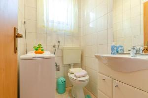 a bathroom with a toilet and a sink at House Ivana in Blato