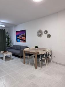 a living room with a table and a couch at Medano Dunas de Oro in El Médano