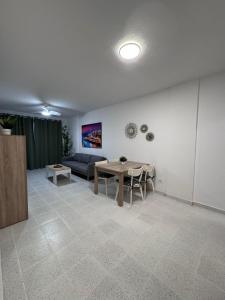a living room with a table and a couch at Medano Dunas de Oro in El Médano +11 photos