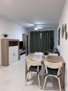 a living room with a wooden table and chairs at Medano Dunas de Oro in El Médano