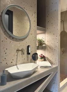 a bathroom with a sink and a mirror at Central Luxury Apartment Maison De Luxx A10 in Larisa