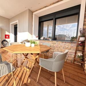 a dining room with a wooden table and chairs at Central Luxury Apartment Maison De Luxx A10 in Larisa