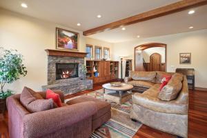a living room with two couches and a fireplace at Drake Park Villa in Bend
