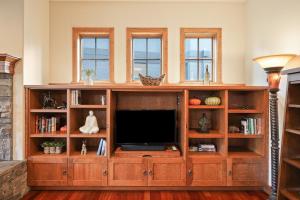 a entertainment center with a television in a living room at Drake Park Villa in Bend +55 photos