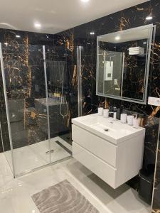 a bathroom with a white sink and a shower at Oberhausen Mitte in Oberhausen +17 photos