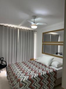 a bedroom with a bed and a large window at Acean Garden in Cabo Frio