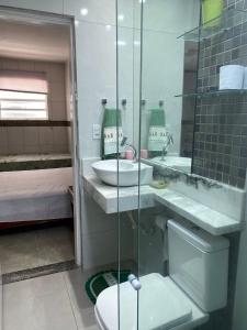 a bathroom with a toilet and a sink and a shower at Casa à 700m da Praia de Atalaia! in Aracaju +11 photos