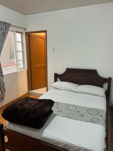 Postel nebo postele na pokoji v ubytování Hostal Casa Primavera