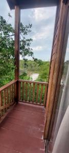 a wooden balcony with a view of the ocean at Cabaña Punta Cocos in Holbox Island