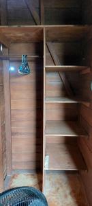 a closet with wooden shelves in a room at Cabaña Punta Cocos in Holbox Island