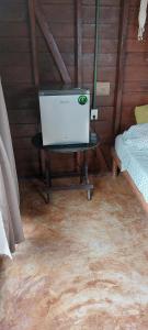 a room with a bed and a table in a room at Cabaña Punta Cocos in Holbox Island