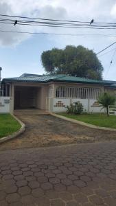 a house with a driveway in front of it at Apartement Graniet in Paramaribo