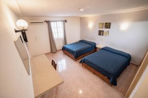 Postel nebo postele na pokoji v ubytování Hotel Rivemar