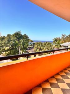 a view from the balcony of a resort with palm trees at Mayas Apartment in Montego Bay