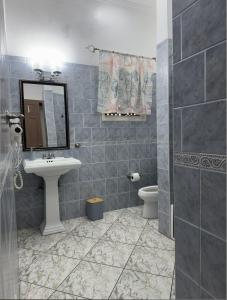 a bathroom with a sink and a toilet at Mayas Apartment in Montego Bay +18 photos