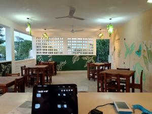 a restaurant with wooden tables and chairs and a ceiling at VILLA GABRIELA Hotel & Villas - EDEN RESTAURANT in Celestún +21 photos
