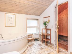 a bathroom with a tub and a window at Tranquil Haven in Lyngsa - By Traum Ferienwohnungen in Sæby +34 photos