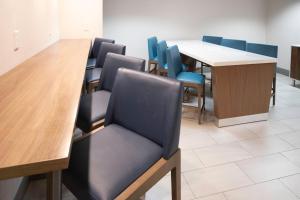 a conference room with a long table and blue chairs at Holiday Inn Express - Canyon by IHG in Canyon +89 photos